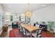 Open dining area with a large wooden table, modern chandelier, flowing to kitchen at 584 Bismark Ne Rd, Atlanta, GA 30324