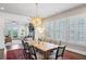 Elegant dining room featuring a large wooden table, designer chandelier, and ample natural light at 584 Bismark Ne Rd, Atlanta, GA 30324
