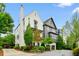 Charming home featuring a mix of white and gray exteriors, surrounded by mature trees and professionally landscaped grounds at 584 Bismark Ne Rd, Atlanta, GA 30324