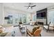 Light-filled living room with fireplace, French doors, neutral decor, and modern ceiling fan at 584 Bismark Ne Rd, Atlanta, GA 30324