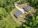 An aerial view shows the home's new roof and landscaping, set in a private lot with mature trees at 165 6Th St, Auburn, GA 30011