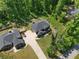 Aerial view of a two-story home with a gray roof, lush landscaping, and a long driveway at 165 6Th St, Auburn, GA 30011