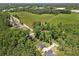 Aerial view showing the house surrounded by woods and greenery with a spacious lawn at 165 6Th St, Auburn, GA 30011