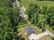 Aerial view of a home with nice landscaping situated on a large lot with mature trees at 165 6Th St, Auburn, GA 30011