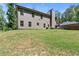 Beautiful backyard and landscaping, showing the home's exterior, yard, and mature trees at 165 6Th St, Auburn, GA 30011