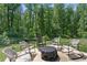 Outdoor patio surrounded by lush trees featuring outdoor seating area, perfect for relaxation and entertainment at 165 6Th St, Auburn, GA 30011
