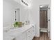 Bright bathroom featuring double sinks, white cabinetry, and a separate shower area with modern fixtures at 165 6Th St, Auburn, GA 30011