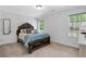 Charming bedroom with ornate bedframe, blue bedding, and natural light from two windows at 165 6Th St, Auburn, GA 30011
