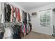 Walk-in closet with ample hanging space, shelving, and a window for natural light at 165 6Th St, Auburn, GA 30011