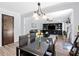 Dining room open to living area featuring modern light fixture and views to the entertainment center at 165 6Th St, Auburn, GA 30011