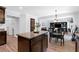 Open-concept kitchen and dining area with a large island, hardwood floors, and views to the living room at 165 6Th St, Auburn, GA 30011