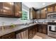 Well-equipped kitchen featuring granite counters, stainless steel appliances, and abundant cabinet space for storage at 165 6Th St, Auburn, GA 30011