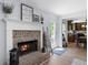 Charming living room shows seamless transition to kitchen, complemented by brick fireplace and cozy seating arrangement at 165 6Th St, Auburn, GA 30011