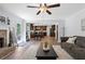 Open-concept living space connects living room, dining area, and kitchen, enhancing space with neutral tones and modern amenities at 165 6Th St, Auburn, GA 30011