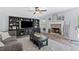 Living room features a brick fireplace, built-in entertainment center, ceiling fan, and access to the backyard at 165 6Th St, Auburn, GA 30011
