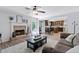 Inviting living room boasts a brick fireplace, ceiling fan, and an open floor plan to the kitchen at 165 6Th St, Auburn, GA 30011