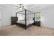 Large bedroom featuring a four poster bed frame, carpeted floors, and a ceiling fan at 165 6Th St, Auburn, GA 30011