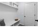 Well-organized mudroom with built-in storage, shelving, and a bench for added convenience at 165 6Th St, Auburn, GA 30011