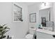 Well-lit powder room with a stylish mirror, vanity, and fixtures, complemented by plant decor at 165 6Th St, Auburn, GA 30011