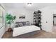 Bedroom featuring a sitting area with a grey loveseat, bookshelf, and a large indoor plant at 165 6Th St, Auburn, GA 30011