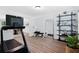 Bright workout area with a treadmill, shelving, and mirror, promoting a healthy and active lifestyle at 165 6Th St, Auburn, GA 30011