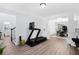 Bright workout room with an exercise machine and access to the dining room and stairwell at 165 6Th St, Auburn, GA 30011