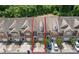 Aerial view of townhome, highlighting its front exterior, landscaping, and parking area at 1880 Garbrooke Cv, Lawrenceville, GA 30046