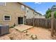 Backyard with small concrete patio, and wood fence at 1880 Garbrooke Cv, Lawrenceville, GA 30046