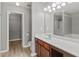 Bathroom with a large vanity, a walk-in closet, a mirror, and a glass door shower at 1880 Garbrooke Cv, Lawrenceville, GA 30046