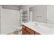 Bright bathroom with a tub-shower combination, a large mirror, and a single sink vanity at 1880 Garbrooke Cv, Lawrenceville, GA 30046