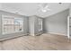 Spacious bedroom with two windows and light-colored walls with white trim at 1880 Garbrooke Cv, Lawrenceville, GA 30046