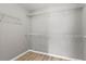 Walk-in closet with white wire shelving and laminate flooring at 1880 Garbrooke Cv, Lawrenceville, GA 30046