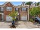 Charming brick townhouse with an attached garage, mature landscaping and front yard parking spaces at 1880 Garbrooke Cv, Lawrenceville, GA 30046