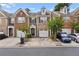 Charming brick townhouse with an attached garage, mature landscaping and front yard parking spaces at 1880 Garbrooke Cv, Lawrenceville, GA 30046