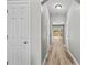 Bright hallway featuring wood-look flooring, a neutral color palette, and arched ceilings at 1880 Garbrooke Cv, Lawrenceville, GA 30046