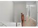 Hallway with wood-look floors, neutral walls, and classic wooden banister at 1880 Garbrooke Cv, Lawrenceville, GA 30046
