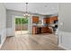Well-lit kitchen with stainless steel appliances, dark countertops and wood-look flooring with slider door access at 1880 Garbrooke Cv, Lawrenceville, GA 30046