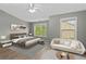 Stylishly furnished primary bedroom features neutral decor, ample natural light, and modern furnishings at 1880 Garbrooke Cv, Lawrenceville, GA 30046