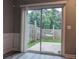View of the patio door leading to the backyard with a hammock visible from the inside at 1880 Garbrooke Cv, Lawrenceville, GA 30046