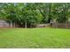 Lush backyard showcasing a spacious lawn and mature trees, creating a serene outdoor setting at 2020 Bixby Se St, Atlanta, GA 30317