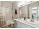 Bathroom showcasing double vanity sinks, elegant lighting, and white tiled shower at 2020 Bixby Se St, Atlanta, GA 30317