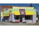 Exterior view of Arden's Garden painted in yellow, green and purple at 2020 Bixby Se St, Atlanta, GA 30317
