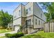 Contemporary home with stone accents, landscaping, and a driveway, showcasing modern design and curb appeal at 2020 Bixby Se St, Atlanta, GA 30317