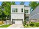 Modern two-story home featuring stone accents, a garage, and landscaped yard for great curb appeal at 2020 Bixby Se St, Atlanta, GA 30317