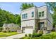 Striking modern two-story home with stone accents, a well-manicured lawn, and a convenient attached garage at 2020 Bixby Se St, Atlanta, GA 30317