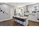 Open concept kitchen features a large island with seating, stainless appliances, and pendant lighting at 2020 Bixby Se St, Atlanta, GA 30317
