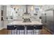 Bright kitchen with white cabinetry, stainless steel appliances, granite counters, and an island with seating at 2020 Bixby Se St, Atlanta, GA 30317