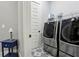 Laundry room with side-by-side stainless steel washer and dryer at 2020 Bixby Se St, Atlanta, GA 30317
