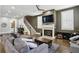 Spacious living room features a cozy fireplace, plush grey sofa, and an adjacent staircase at 2020 Bixby Se St, Atlanta, GA 30317