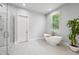 Bright bathroom features a contemporary tub and separate shower at 2020 Bixby Se St, Atlanta, GA 30317